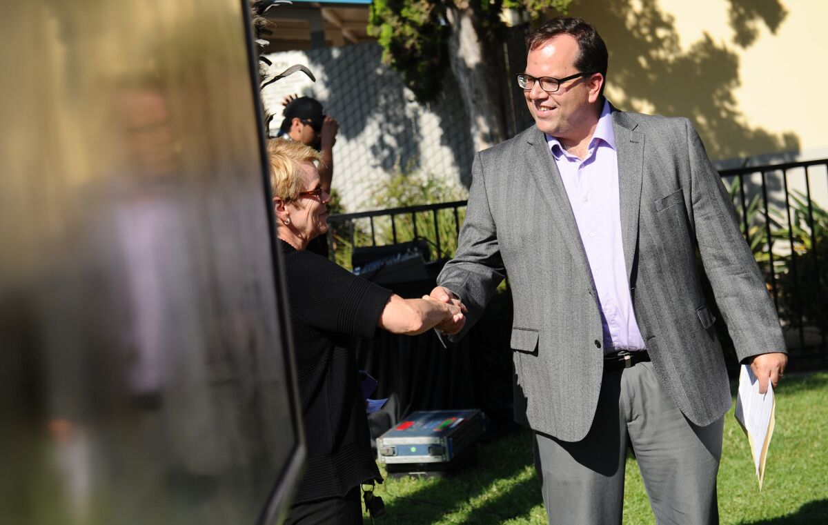 L.A. teachers union President Alex Caputo-Pearl greets people after a 2014 news conference calling for smaller class sizes, fully staffed schools and higher pay for educators. On Wednesday, the union won an internal election over raising dues to pursue these goals.