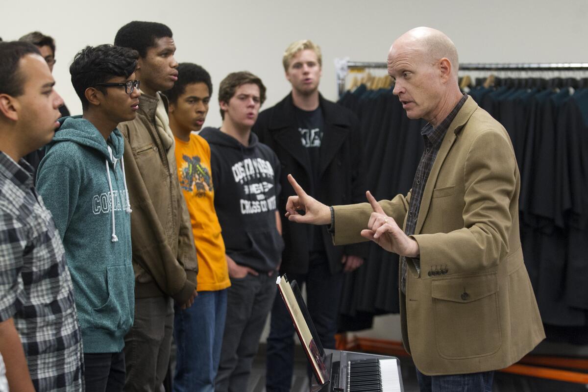 Choir director Jon Lindfors, right, controls the tempo as members of Costa Mesa High School's Madrigal Choir rehearse for an upcoming show at Carnegie Hall in New York.