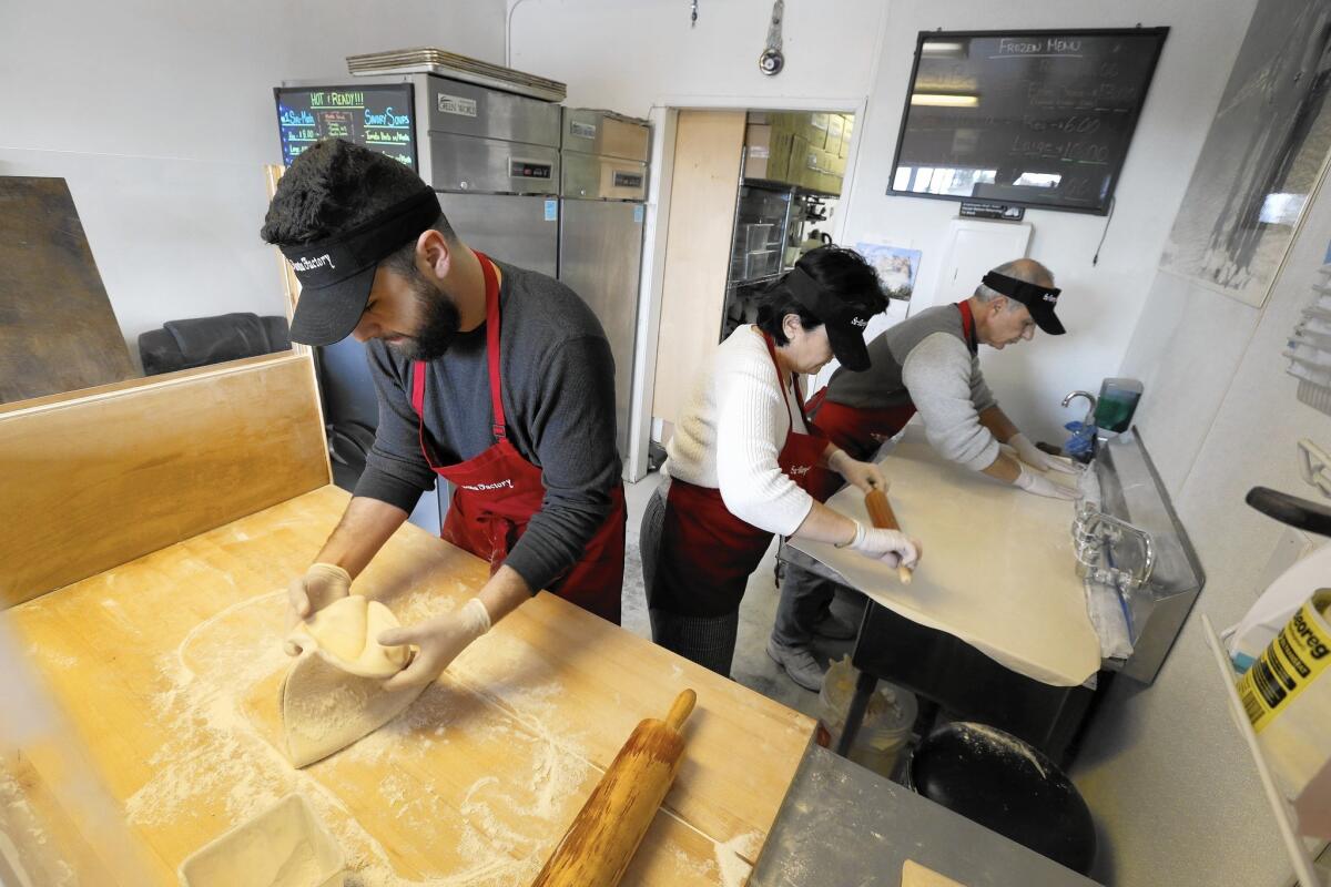 The dumplings are made from scratch by Sarkes, left, and his parents Evelina and Grant Yegiazaryan at the Monta Factory in Pasadena.