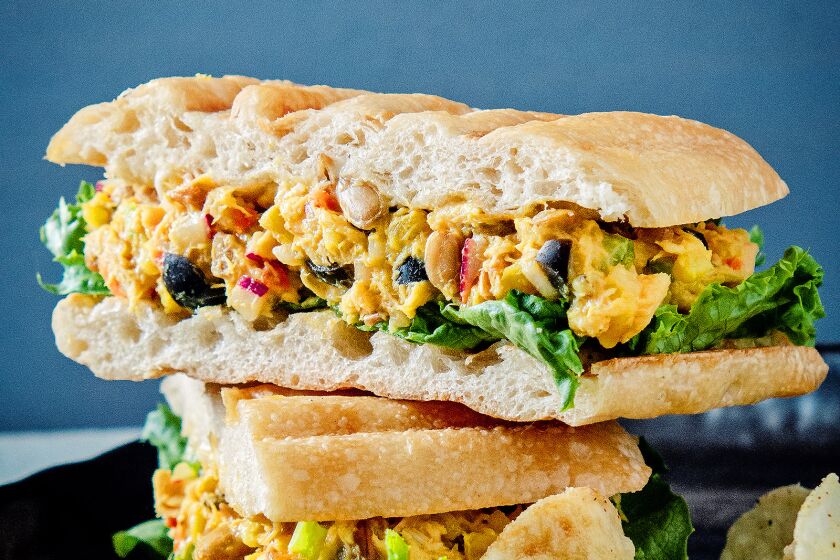 Curried tuna salad sandwich with chips.