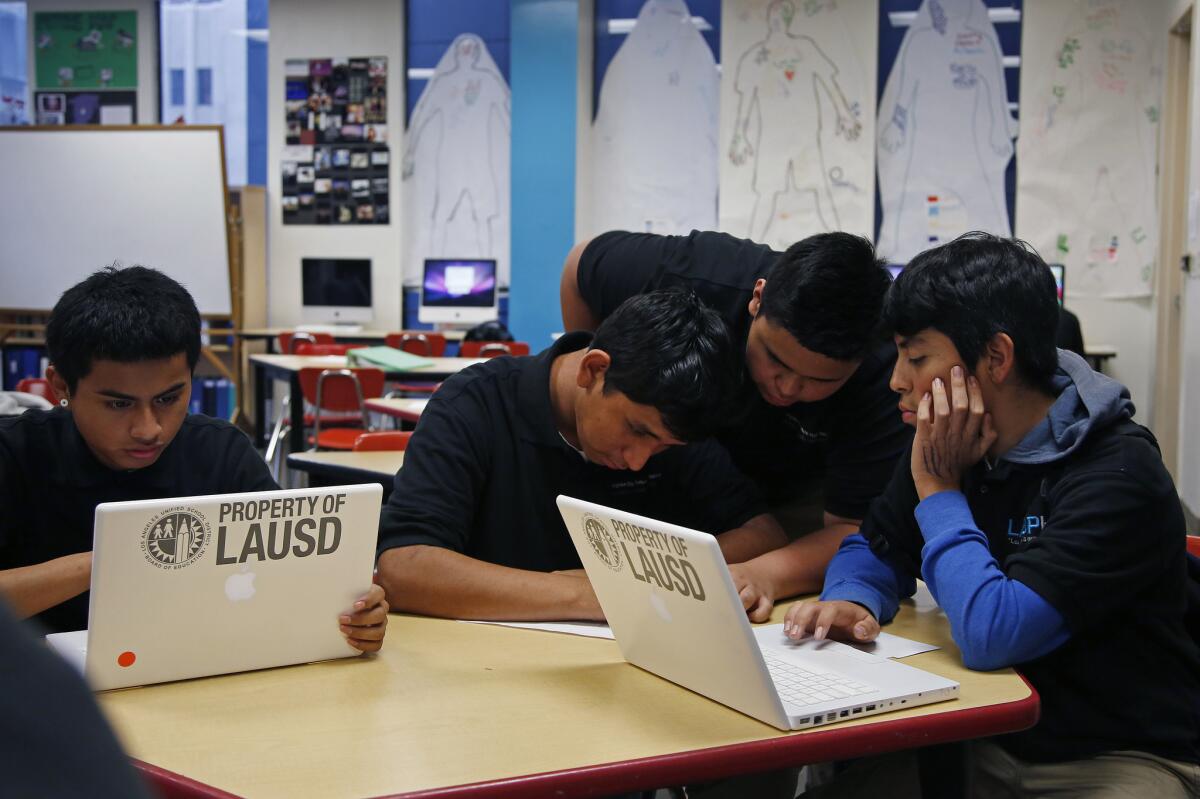 Luis Natalio, Alberto Garcia, Ryan Flores and Milton Hernandez work together in their ninth-grade advisory class at Los Angeles Big Picture High School last December.