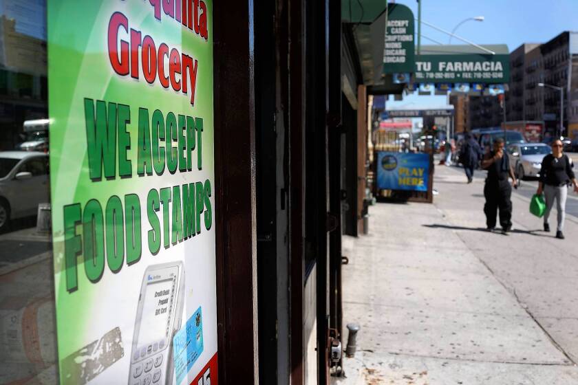 The GOP-controlled House voted this week to pass budget cuts that would kick nearly 4 million people off the food stamps program. Above, a store in New York advertises that it accepts food stamps.