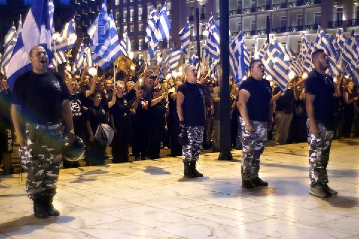 Members and supporters of the far-right Golden Dawn party sing the Greek national anthem in front of the parliament building in Athens during a rally marking the anniversary of the fall of Constantinople to the Ottoman Empire in 1453.