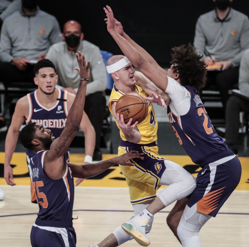 Lakers guard Alex Caruso collides with Phoenix Suns forward Cameron Johnson.