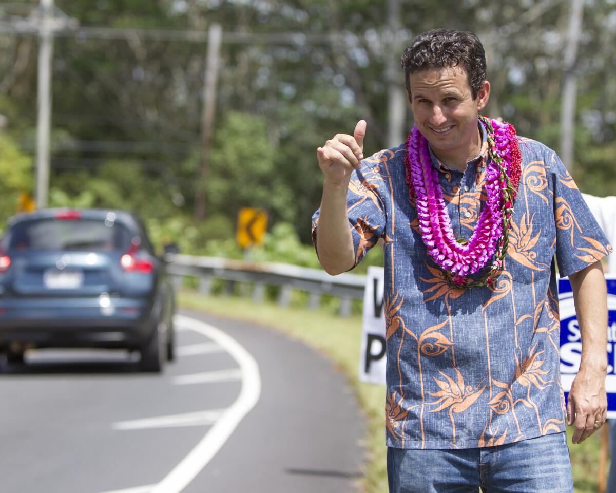U.S. Sen. Brian Schatz does some last-minute campaigning near a polling place where makeup balloting was held Friday. Two precincts had been closed during the Aug. 9 statewide primary because of storm damage.