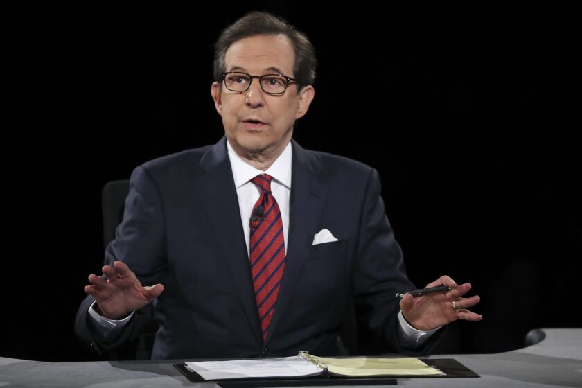 Moderator Chris Wallace of FOX News guides the discussion between Hillary Clinton and Donald Trump during the third presidential debate at UNLV in Las Vegas.