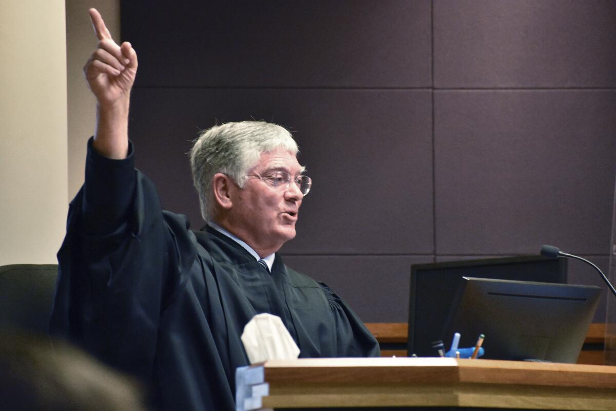 Montana District Judge Michael Moses gestures