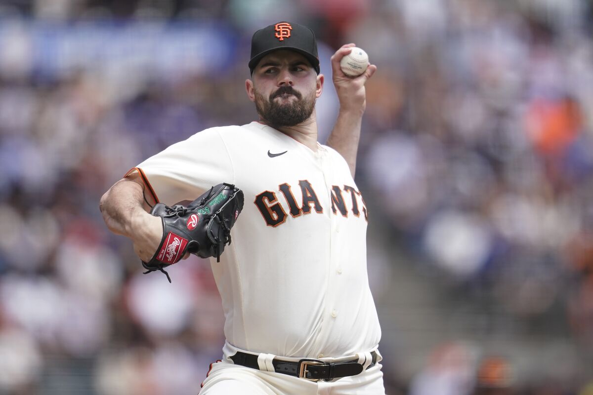San Francisco Giants' Carlos Rodon pitches against the Los Angeles Dodgers during the first inning of a baseball game in San Francisco, Sunday, June 12, 2022. (AP Photo/Jeff Chiu)