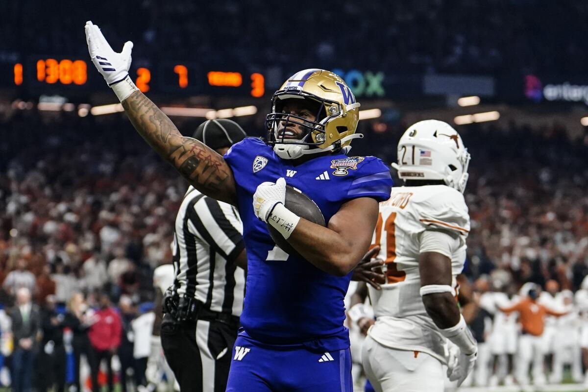 Washington running back Dillon Johnson celebrates after scoring a touchdown against Texas in the Sugar Bowl on Jan. 1.