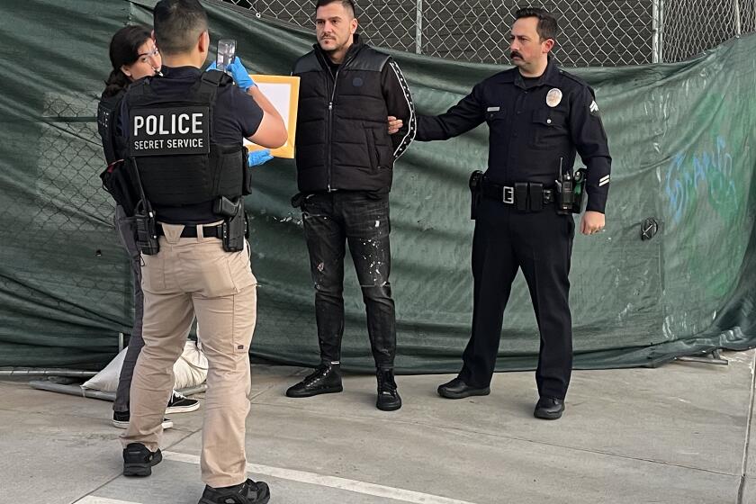 TARZANA CA FEBRUARY 2, 2023 - LAPD and federal officers make an arrested Thursday morning, Feb. 2, 2023 for alleged EBT fraud at a US Bank ATM in Tarzana. Victims had reported their EBT cards had been drained of funds at the ATM near the first of every month. (Rebecca Ellis / Los Angeles Times)