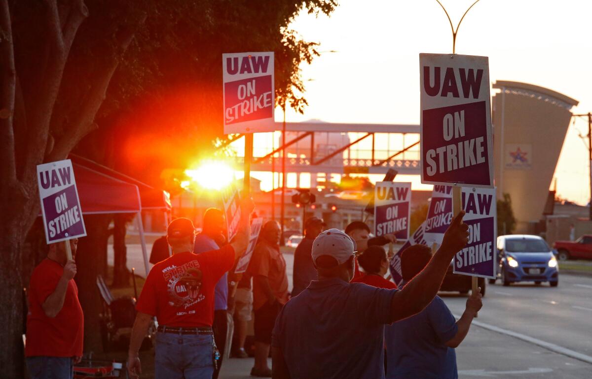 Workers picket outside the General Motors plant in Arlington, Texas, in September. That factory, along with plants in Flint, Mich., and Fort Wayne, Ind., make up 30% of the United Auto Workers’ GM voting membership.