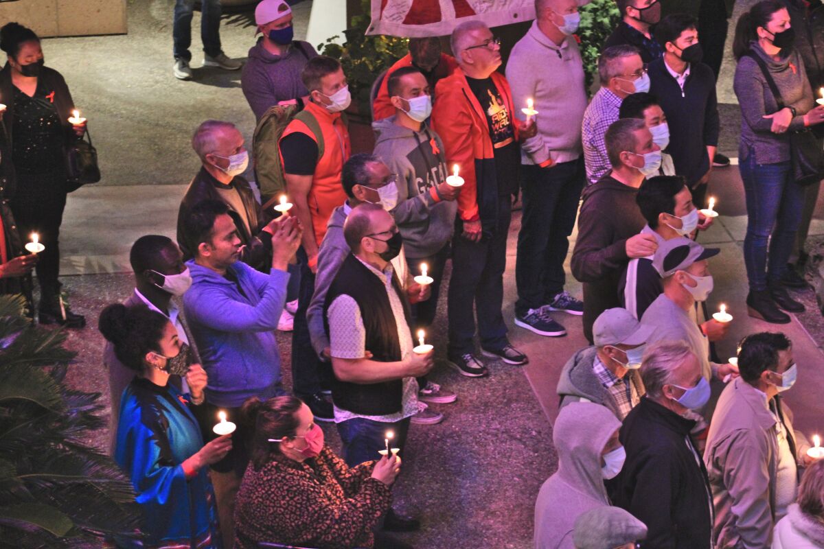 Supporters gather for a vigil hosted by Mama's Kitchen annually on World AIDS Day.