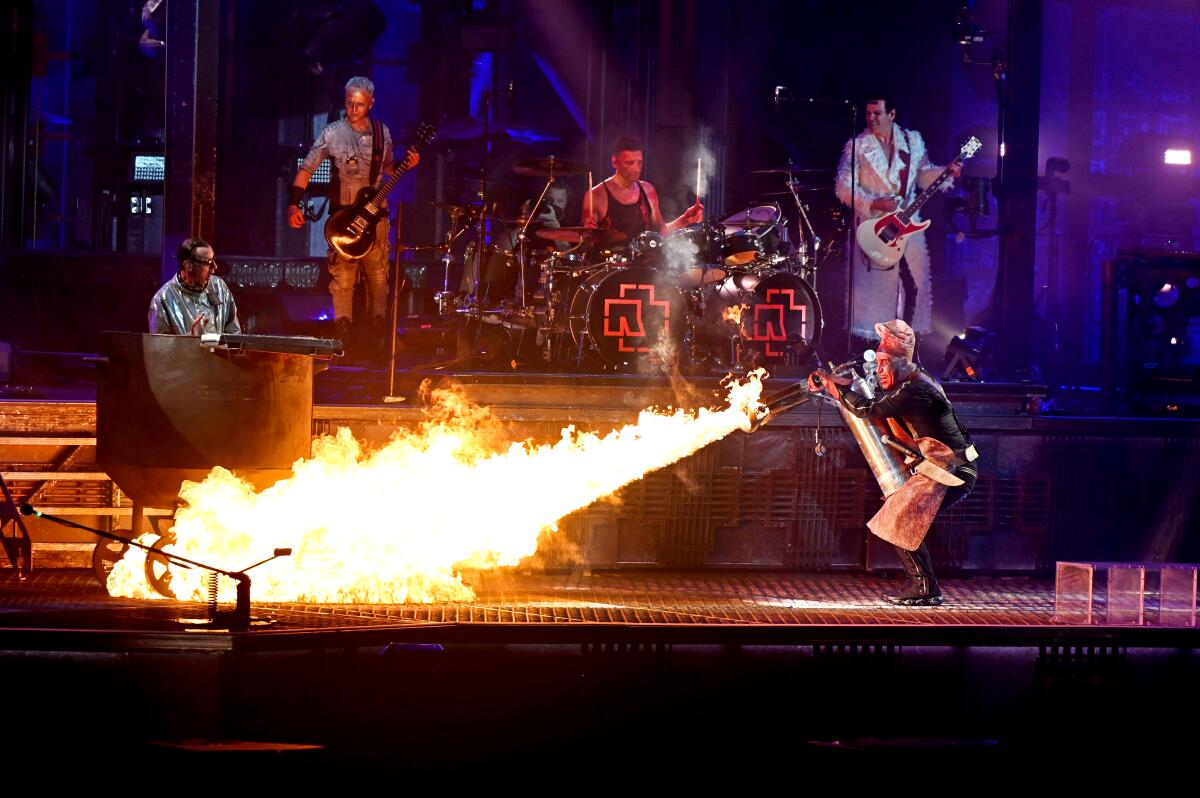 Rammstein’s lead singer Till Lindemann  fires a flamethrower at band member Christian Lorenz onstage.