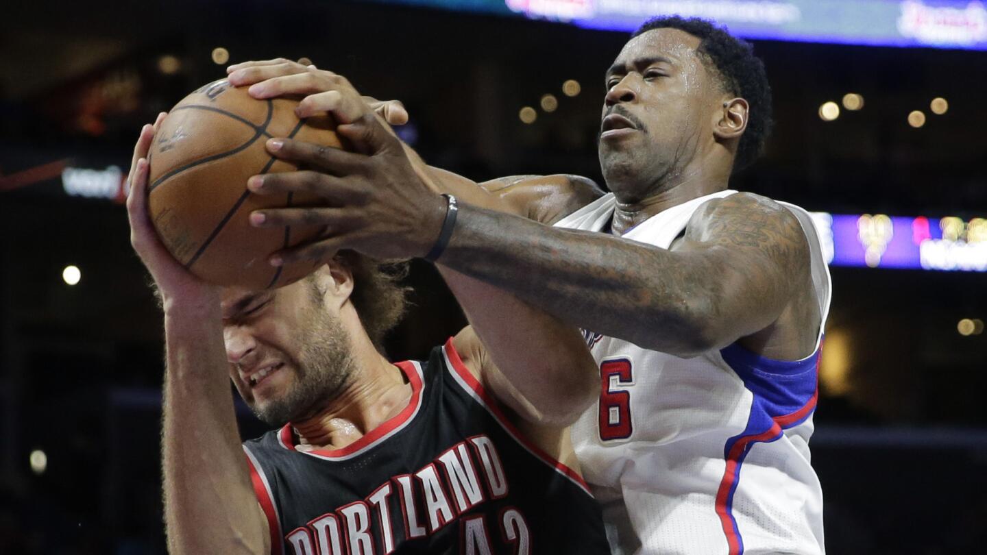 Portland Trail Blazers center Robin Lopez, left, battles Clippers center DeAndre Jordan for a rebound during the first half of Saturday's game at Staples Center.