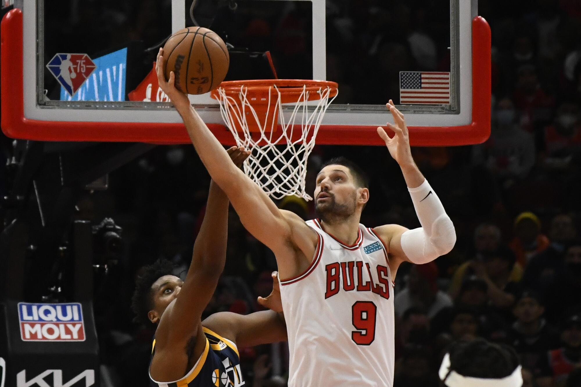 Bulls center Nikola Vucevic grabs a rebound against Jazz center Hassan Whiteside.