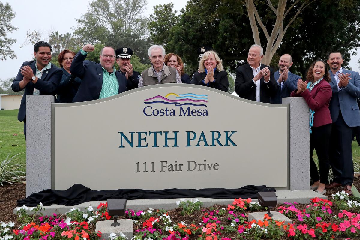 Former Costa Mesa police chief Roger Neth, fifth from left, at the newly named Neth Park during a ceremony Tuesday, Nov. 4. 