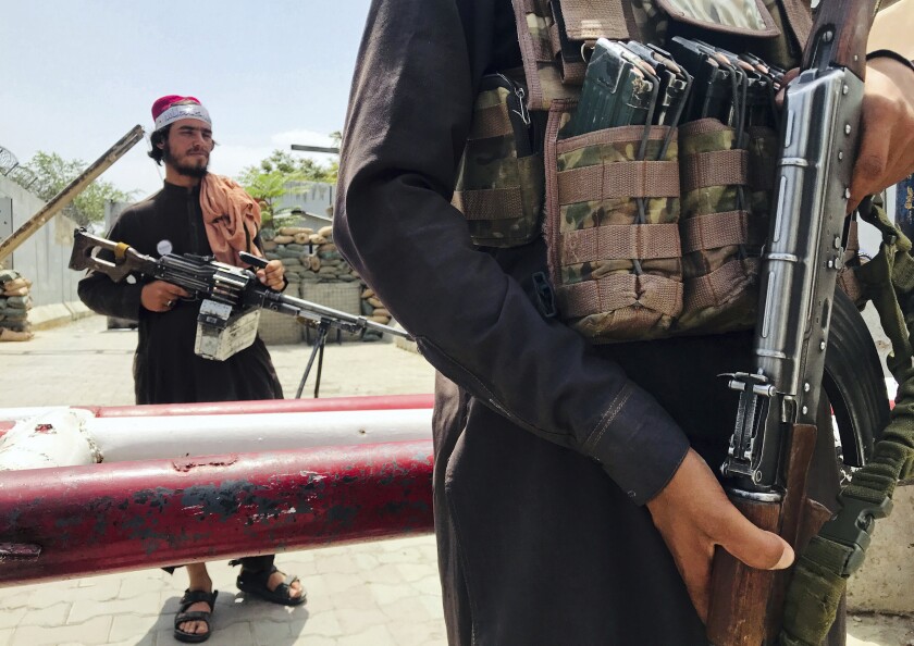 Taliban fighters stand guard at a checkpoint near the U.S. embassy in Kabul, Afghanistan, on Tuesday.