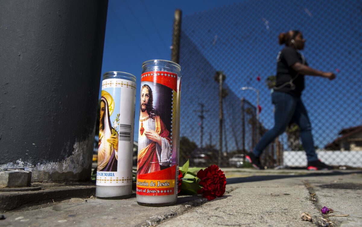 A modest memorial for a man shot and killed on Saturday sits at 81st and Hoover streets in South L.A. on Monday.