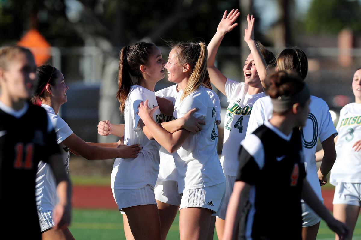 Edison's Alex Wood celebrates scoring a penalty kick with teammates at Fountain Valley High School.