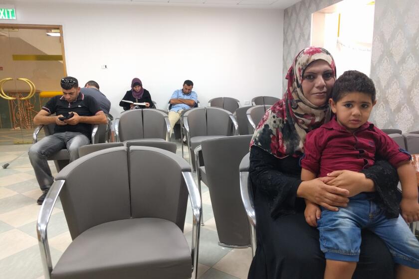 Fathiya Safadi sits in the Razan fertility clinic's waiting room in the West Bank town of Nablus with son Amir, who was conceived using seminal fluid from her husband, Ashraf, that was smuggled out of an Israeli prison.