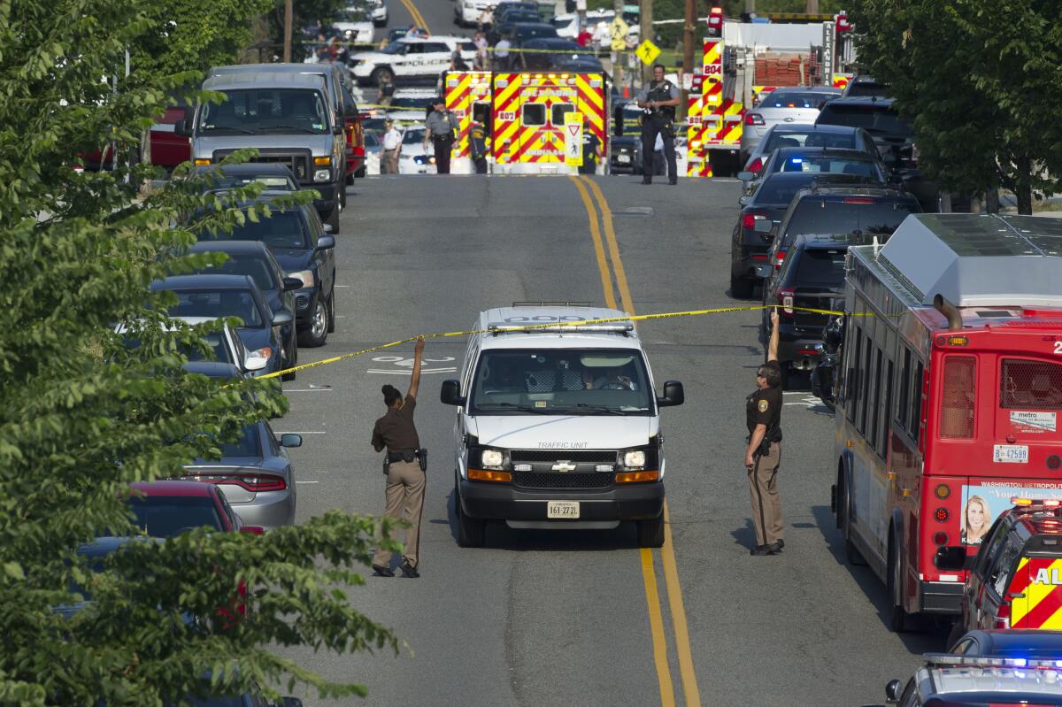 Police and emergency personnel near the scene where House Majority Whip Steve Scalise was shot and wounded during a congressional baseball team practice in Alexandria, Va.