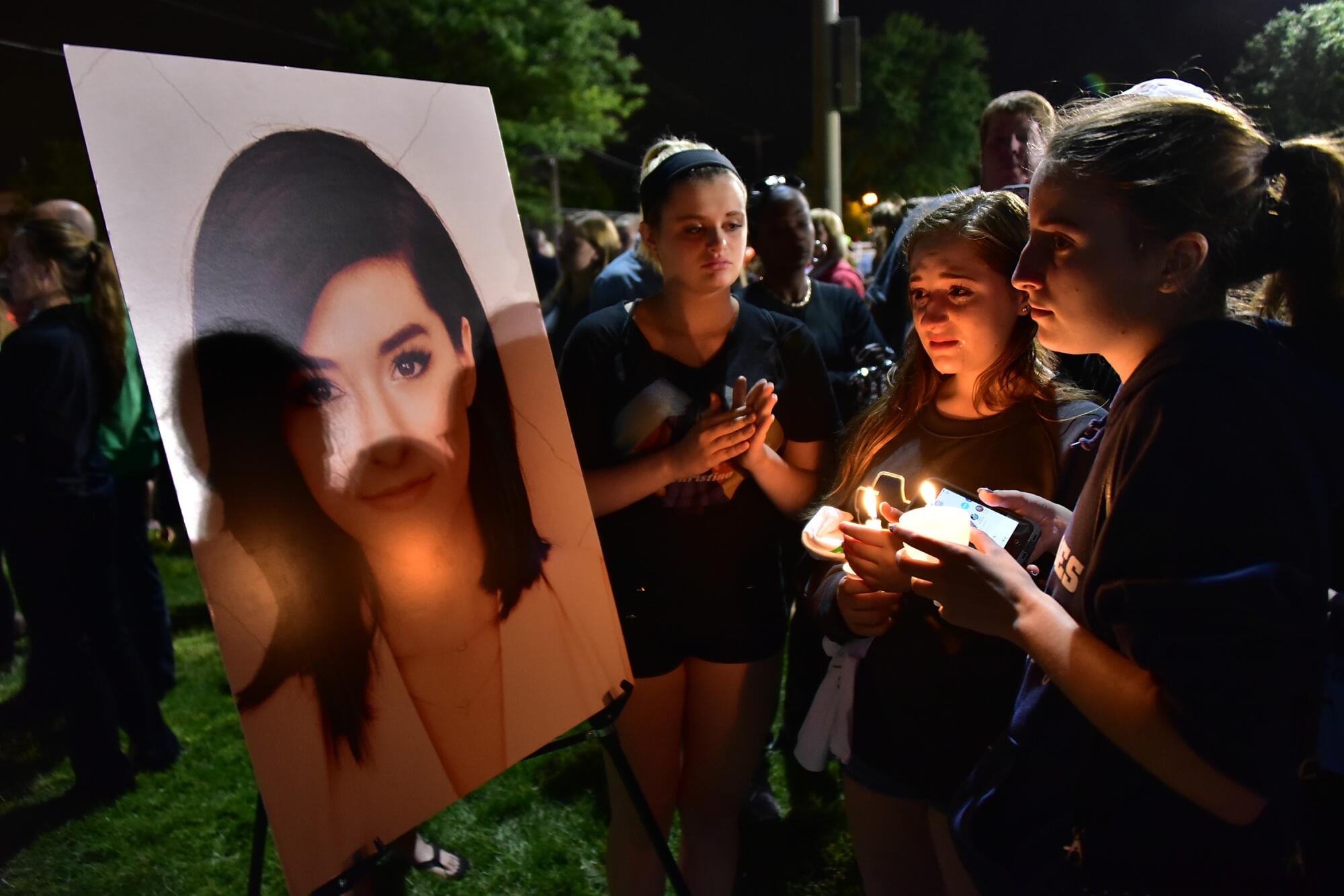 Friends at a vigil for Christina Grimmie on June 13, 2016.
