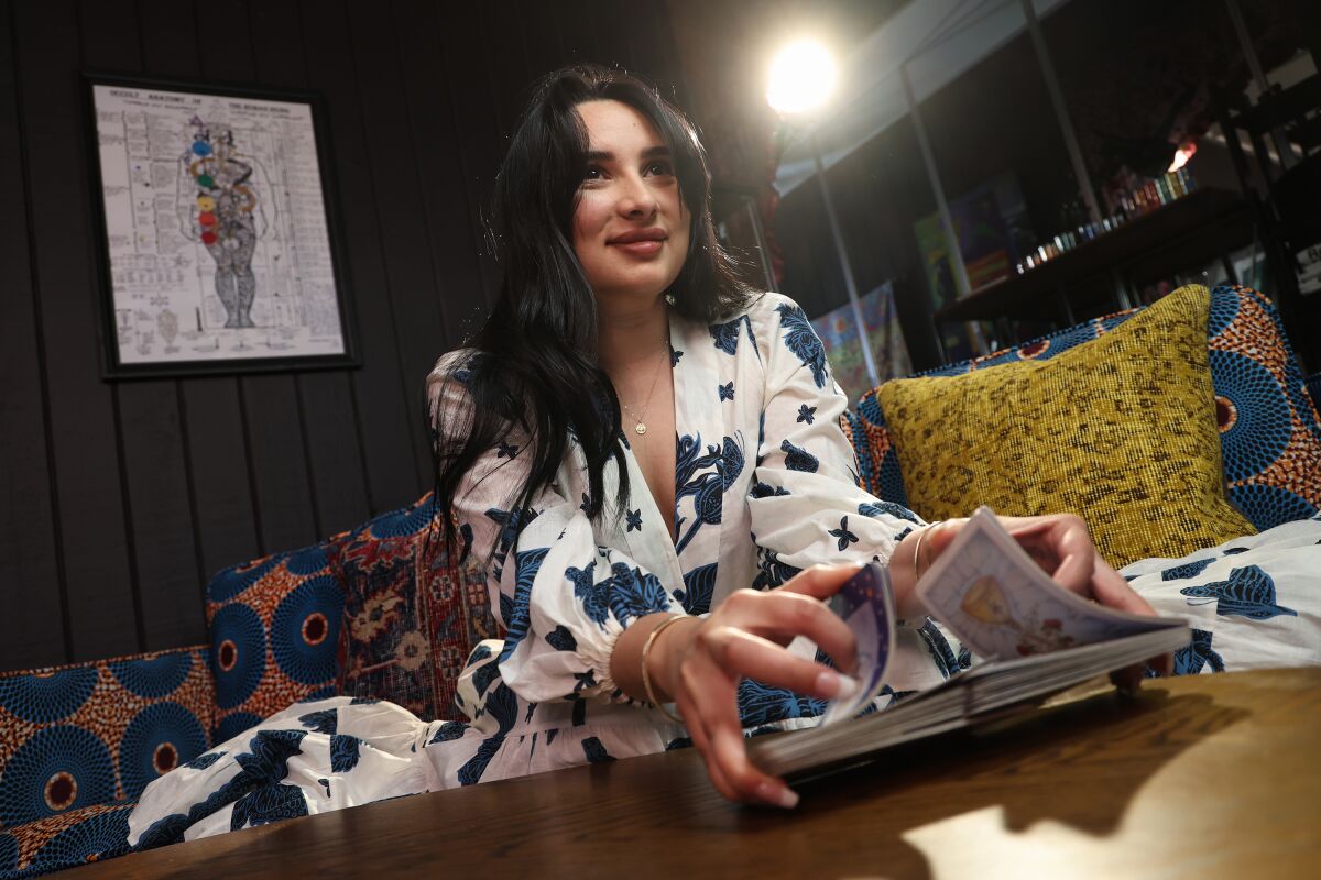 Paulina Stevens, the main source and subject of the upcoming podcast "Foretold," shuffles a deck of tarot cards.