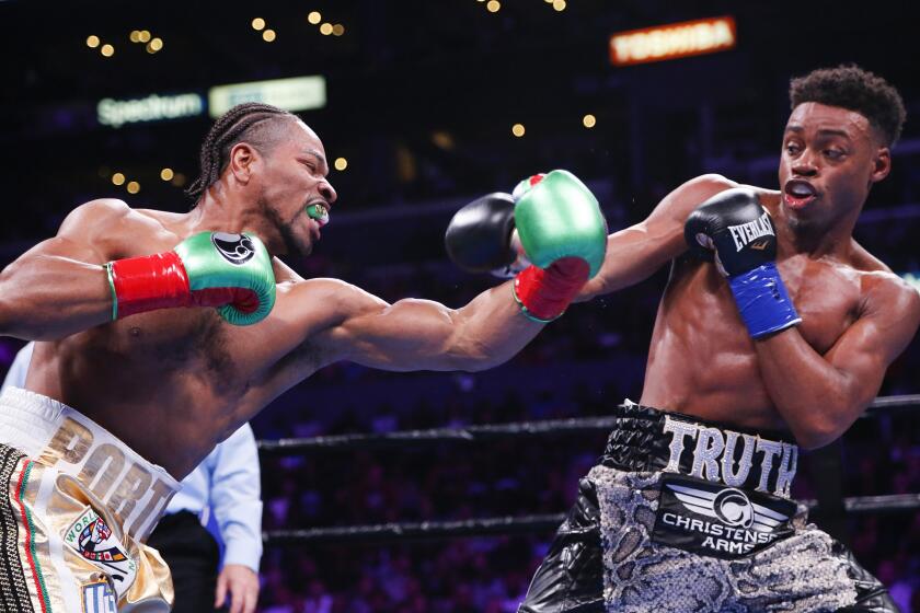 Errol Spence Jr., right, and Shawn Porter exchange punches during the WBC & IBF World Welterweight Championship boxing match Saturday, Sept. 28, 2019, in Los Angeles. (AP Photo/Ringo H.W. Chiu)