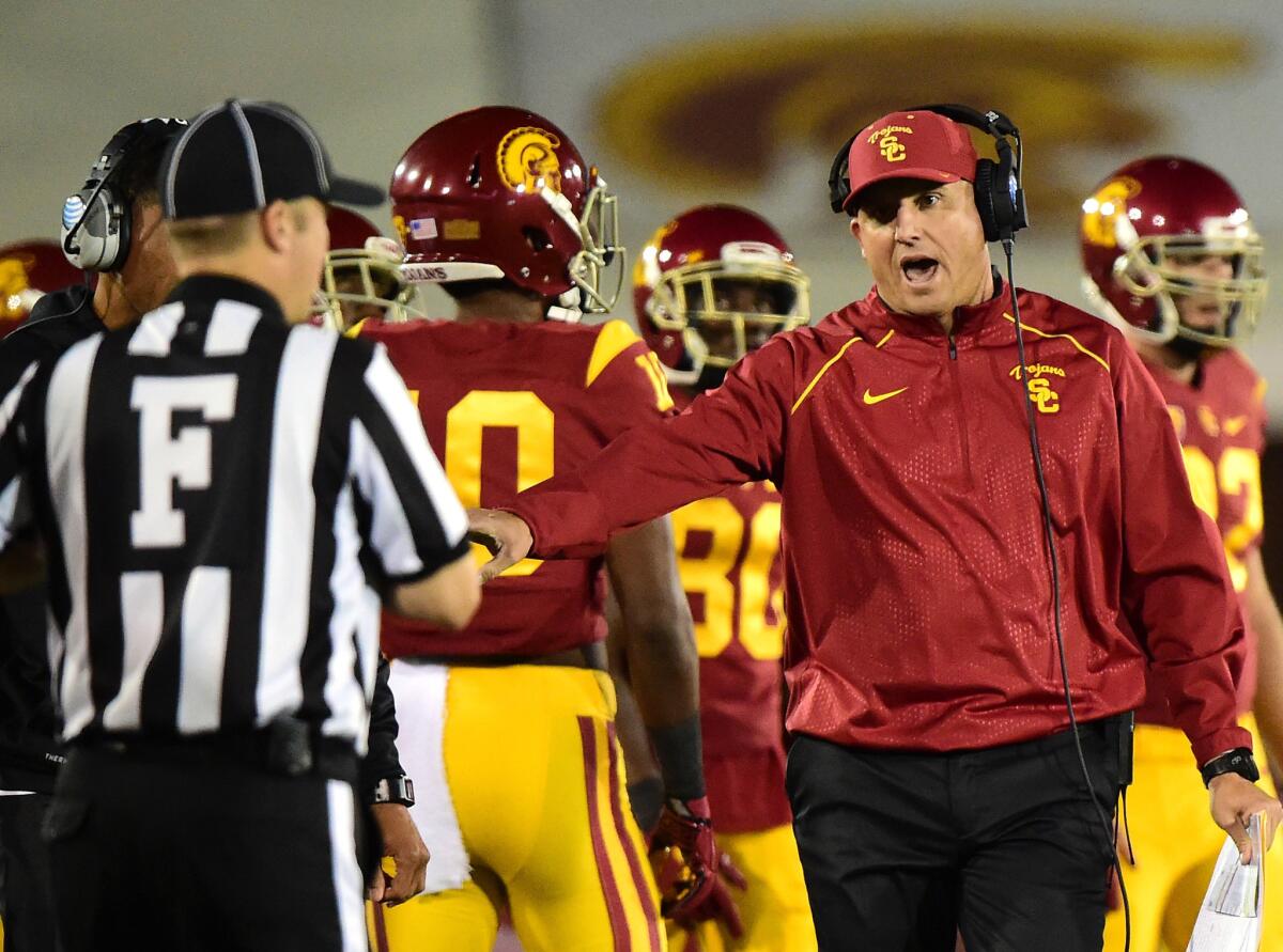 USC Coach Clay Helton complains to an official during the Arizona game.