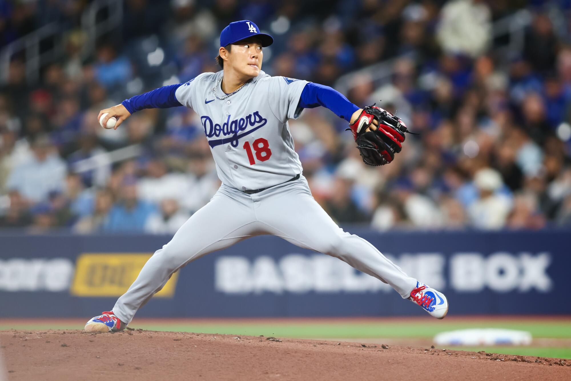 Dodgers starting pitcher Yoshinobu Yamamoto delivers during the first inning against the Toronto Blue Jays.