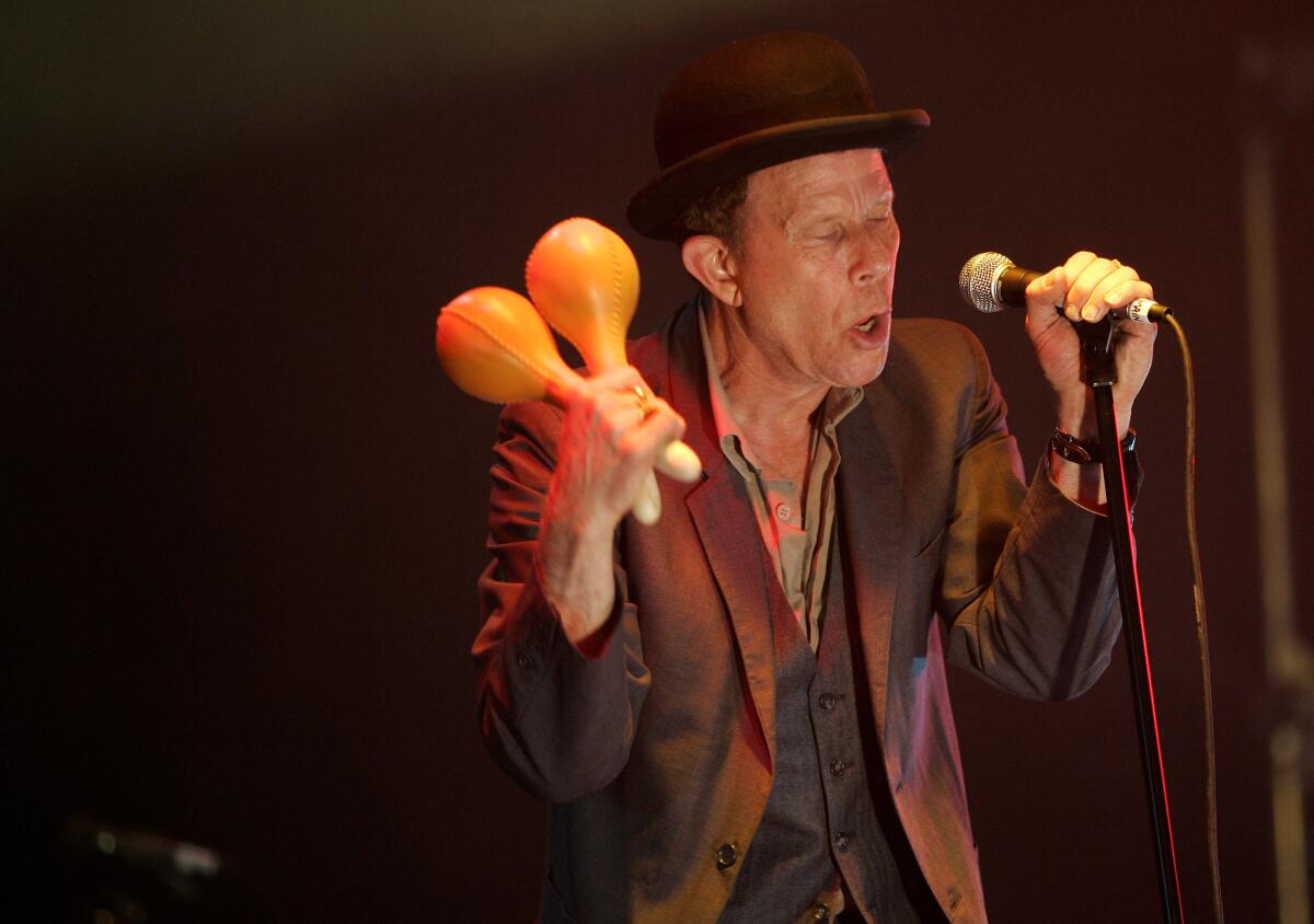 Tom Waits, wearing a hat — probably not the one up for auction. But maybe?