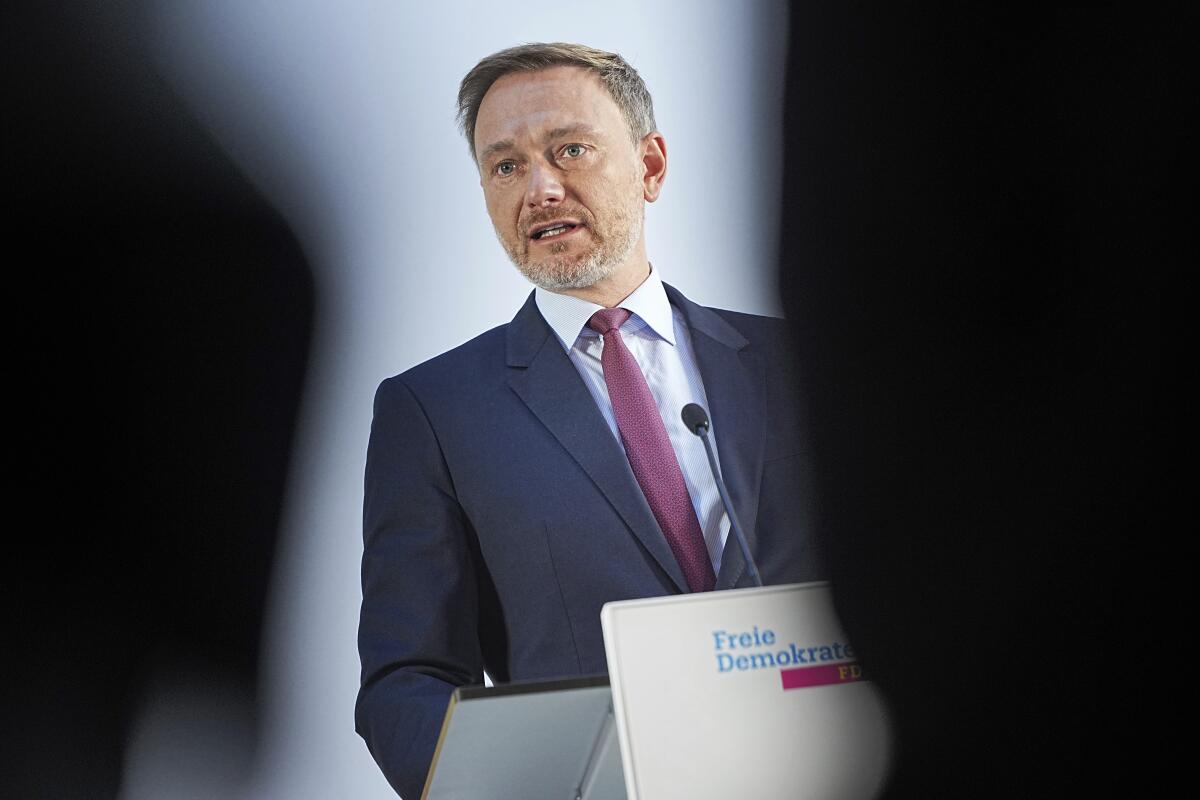 Christian Lindner, chairman of the German Liberal Party (FDP), addresses the media during a press conference on the further course of the exploratory talks in Berlin, Germany, Wednesday, Oct. 6, 2021. Germany’s Liberals say they want to hold negotiations on a new governing coalition under the leadership of outgoing Vice Chancellor Olaf Scholz’s center-left Social Democrats which narrowly won the country’s election. (Michael Kappeler/dpa via AP)