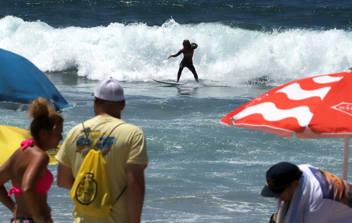 Nadia Erostarbe of Spain rides her wave to the shore during the U.S. Open of Surfing on Friday.