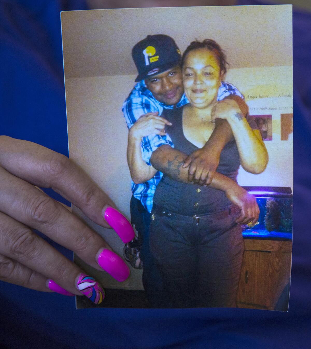 Catherine Howard holds a picture of her son, Kevin Jones. Jones was the city's 13th homicide in 2016. The case is still unsolved. (Gina Ferazzi / Los Angeles Times)