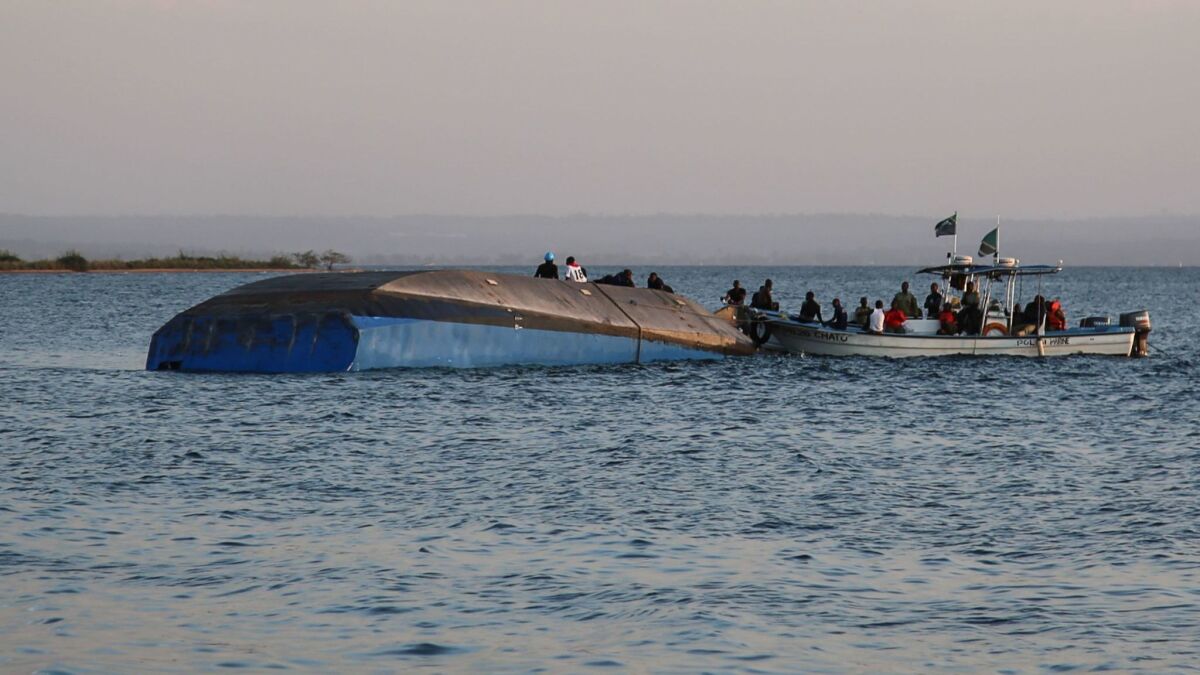 Investigators work on the capsized ferry Nyerere in Lake Victoria, Tanzania, on Sept. 21, 2018.