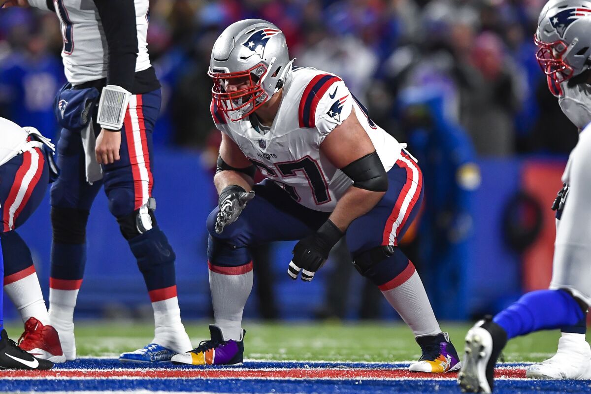 FILE - New England Patriots offensive lineman Ted Karras blocks during the first half of an NFL football game against the Buffalo Bills in Orchard Park, N.Y., Monday, Dec. 6, 2021. Karras has agreed to a free agent contract with the Cincinnati Bengals. (AP Photo/Adrian Kraus, File)