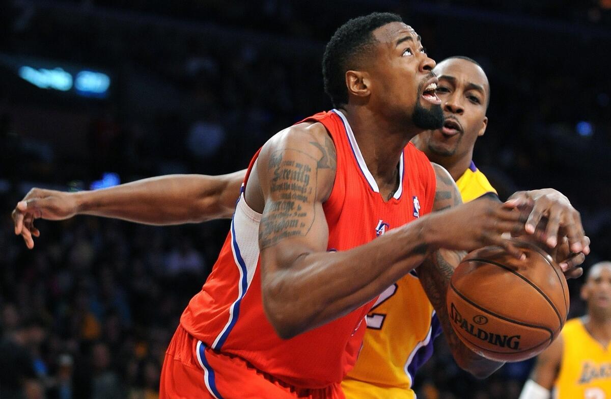 Center DeAndre Jordan, driving to the basket against Lakers center Dwight Howard last week, will remain with the Clippers as they push for a top-four seeding in the Western Conference playoffs.