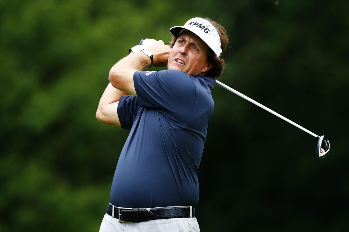 Phil Mickelson watches his tee shot at No. 4 during the first round of the Deutsche Bank Championship at TPC Boston.