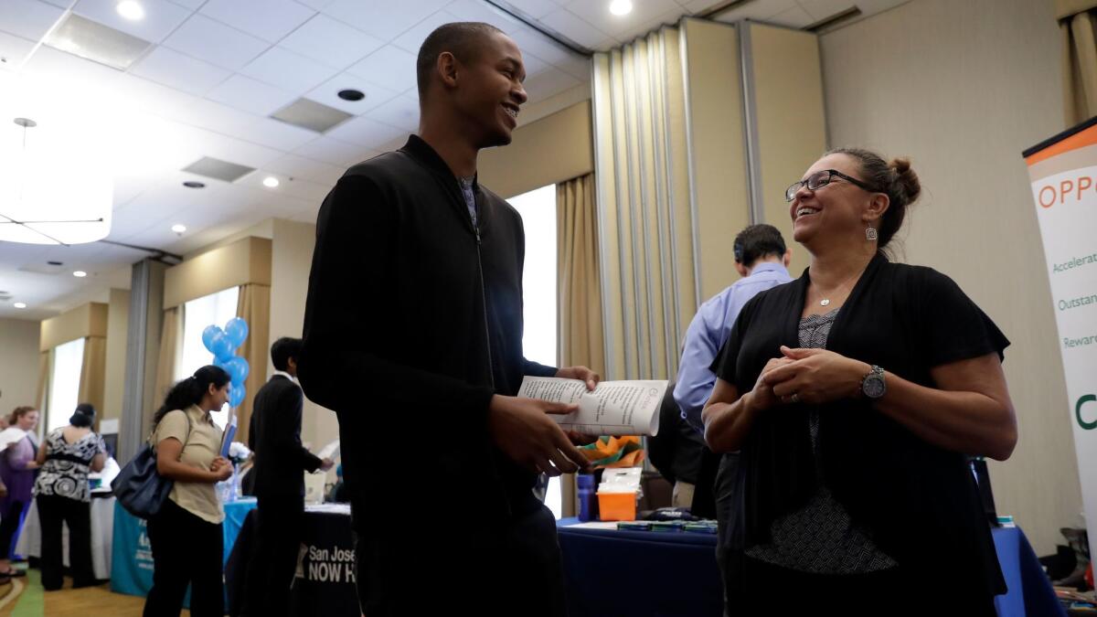 Big 5 Sporting Goods recruiter Kathy Tringali talks to applicant Jarrell Palmer at a job fair in San Jose.
