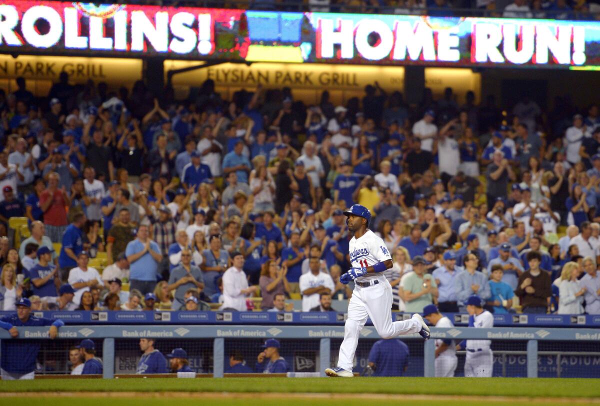 Dodgers shortstop Jimmy Rollins rounds the bases after a solo home run against the Giants.