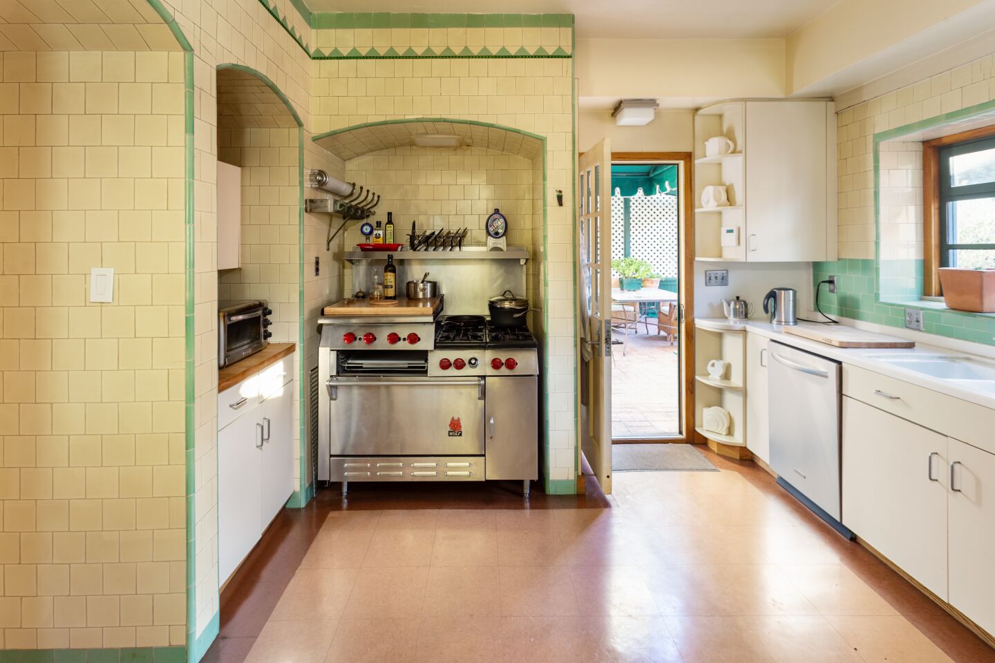The kitchen retains its vintage tilework.