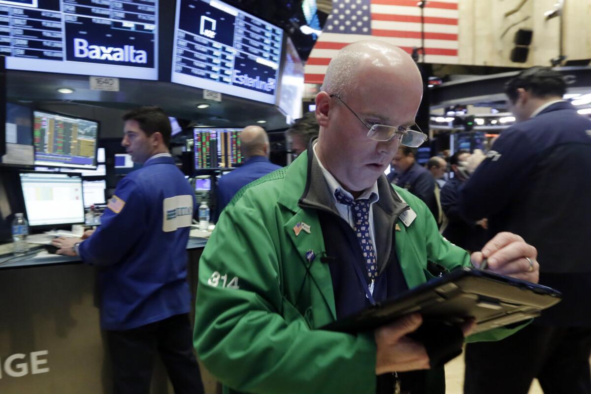 Traders work on the floor of the New York Stock Exchange on Friday.