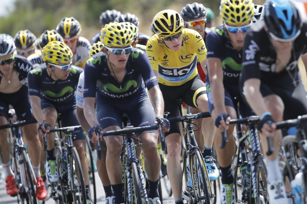 Britain's Chris Froome, wearing the overall leader's yellow jersey, rides in the pack on Friday during the thirteenth stage of the Tour de France.