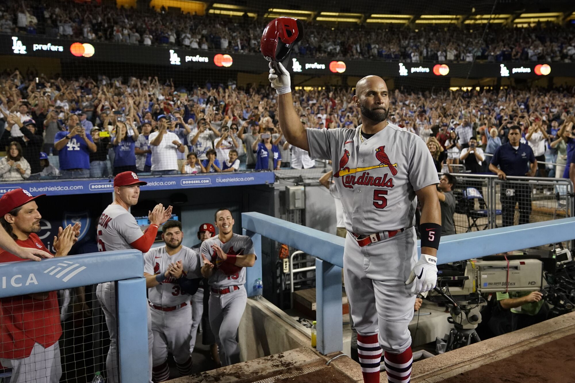 St. Louis Cardinals Designated Hitter Albert Pujols greets fans as he is honored.