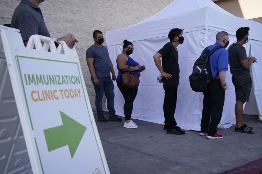 People wait in line for COVID-19 vaccinations at an event at La Bonita market, a Hispanic grocery store, Wednesday, July 7, 2021, in Las Vegas. (AP Photo/John Locher)