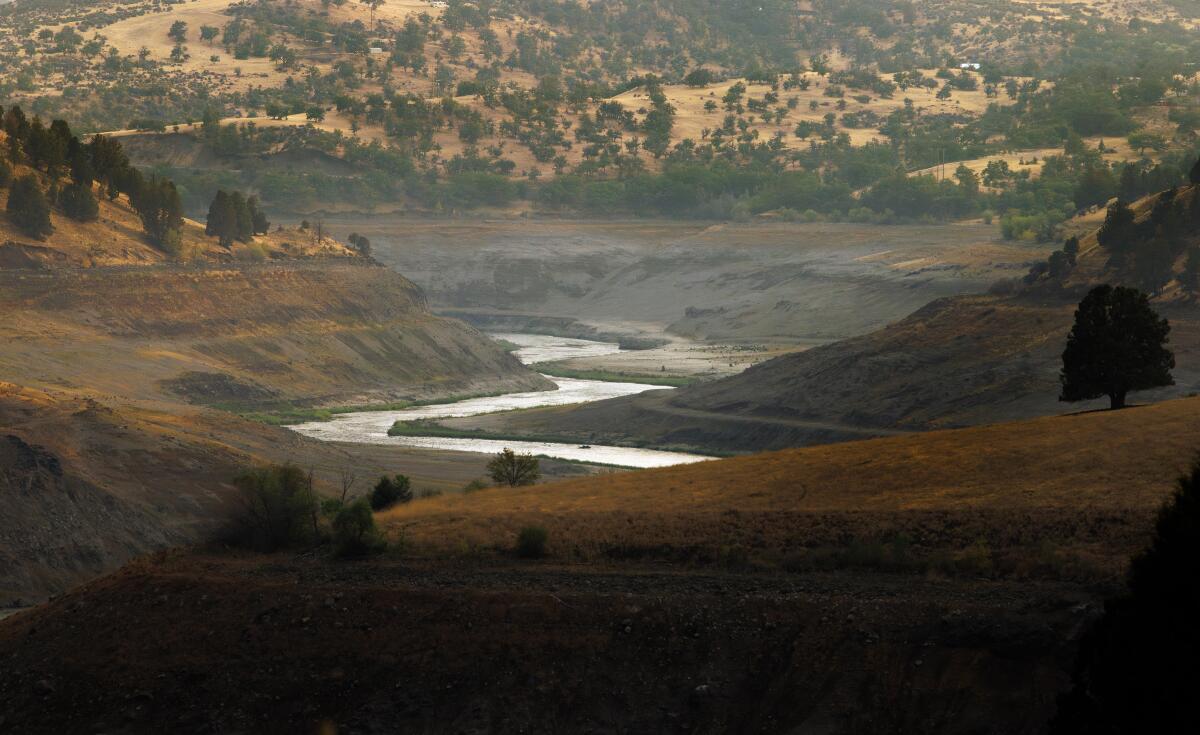 A photo of a river winding through hills