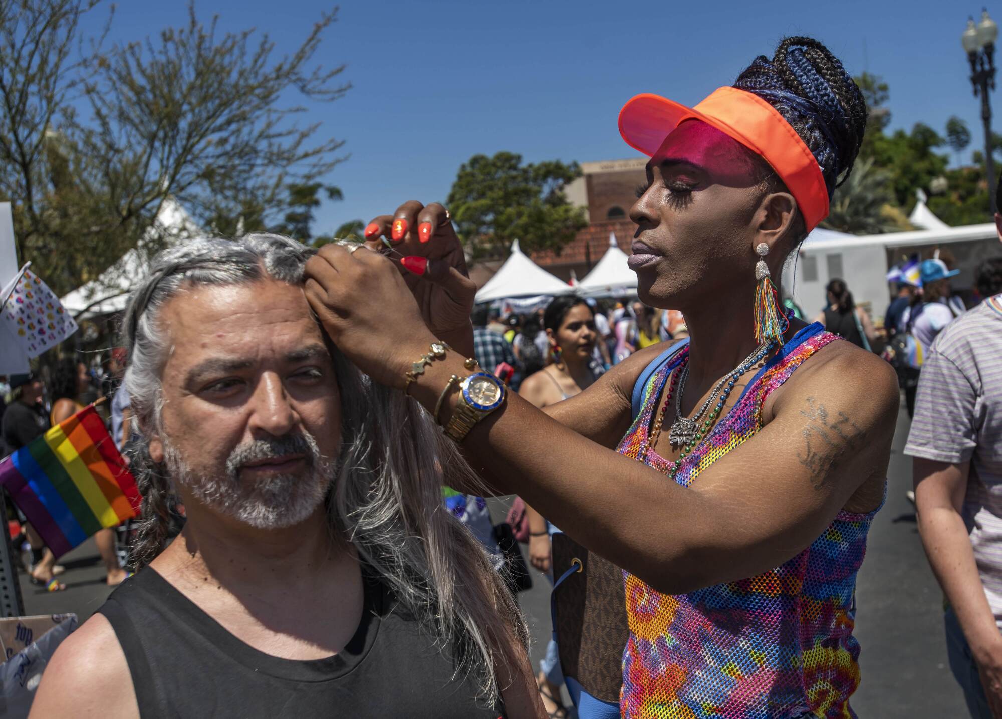 Jeffrey Dixson, right, of Signal Hill, helps Ernie Alvarado, left, of Victorville.