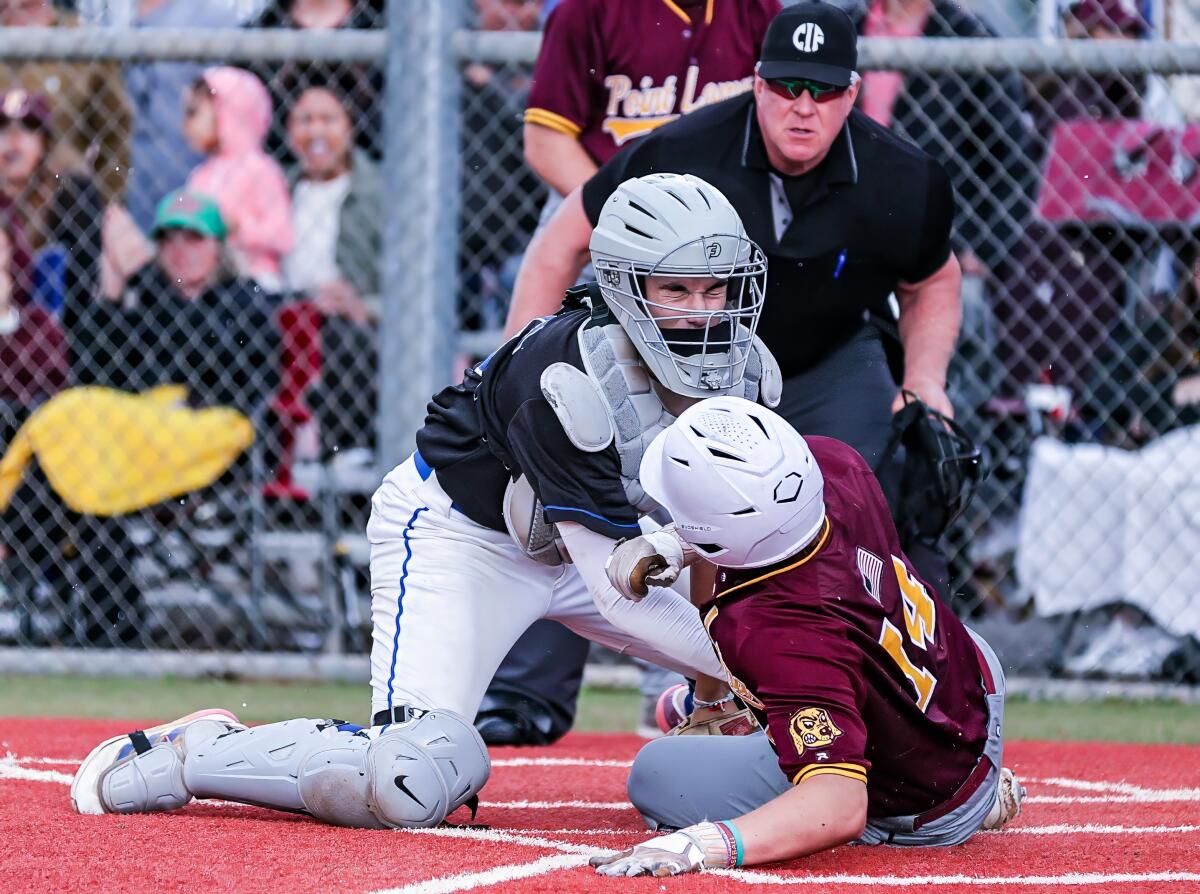 El Camino Real catcher Adan Viner tags out Point Loma's Phoenix Brant on a throw from center field in the first inning.