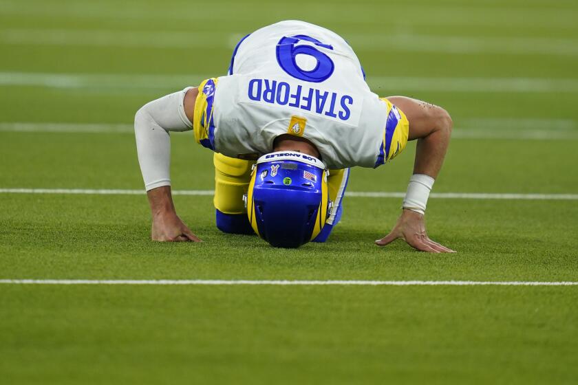 Los Angeles Rams quarterback Matthew Stafford reacts after injuring his ankle while throwing an incomplete pass during the second half of an NFL football game against the Tennessee Titans, Sunday, Nov. 7, 2021, in Inglewood, Calif. (AP Photo/Ashley Landis)