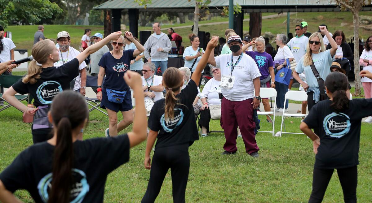 Dance 4 Joy Ministries dancers help walkers warm up Saturday for an annual Walk for Independence at TeWinkle Park.